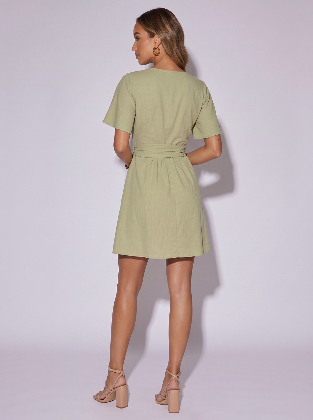 Amsterdam Twist Waist Flutter Sleeve Dress in Sage — back view